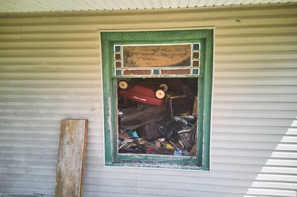 Debris is seen inside a home where authorities say they removed 16 children and arrested four adults in Hamden, Ohio, Wednesday,