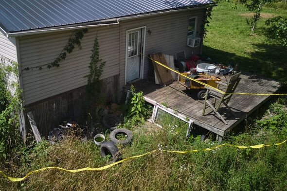 Police tape surrounds a home where authorities say they removed 16 children and arrested four adults in Hamden, Ohio, Wednesday,