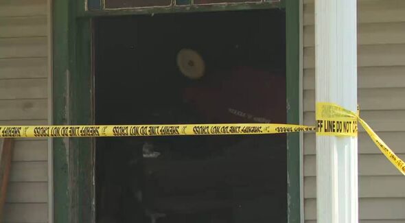 An image depicting a closed entrance with yellow police tape cordoning off the area, suggesting a possible investigation or inci