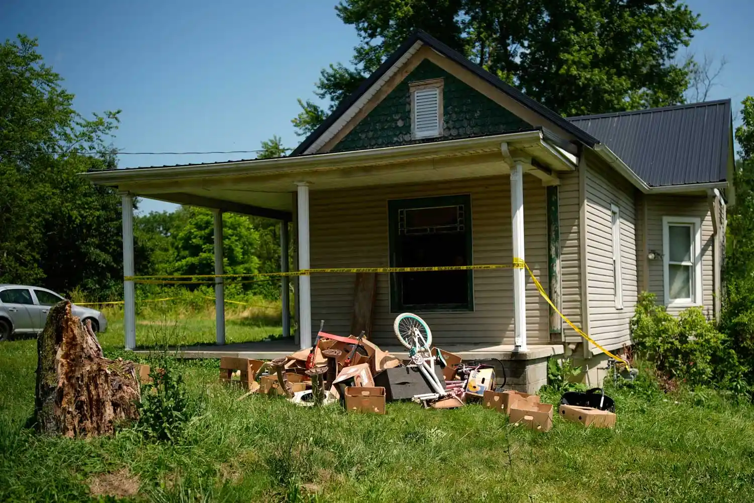 Police tape surrounds a home where authorities say they removed 16 children and arrested four adults in Hamden, Ohio, Wednesday, July 1, 2026.