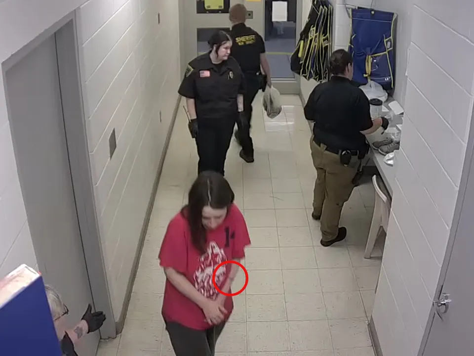 Siders tried to cover up a mark on her left arm as she was booked in jail, footage shows.