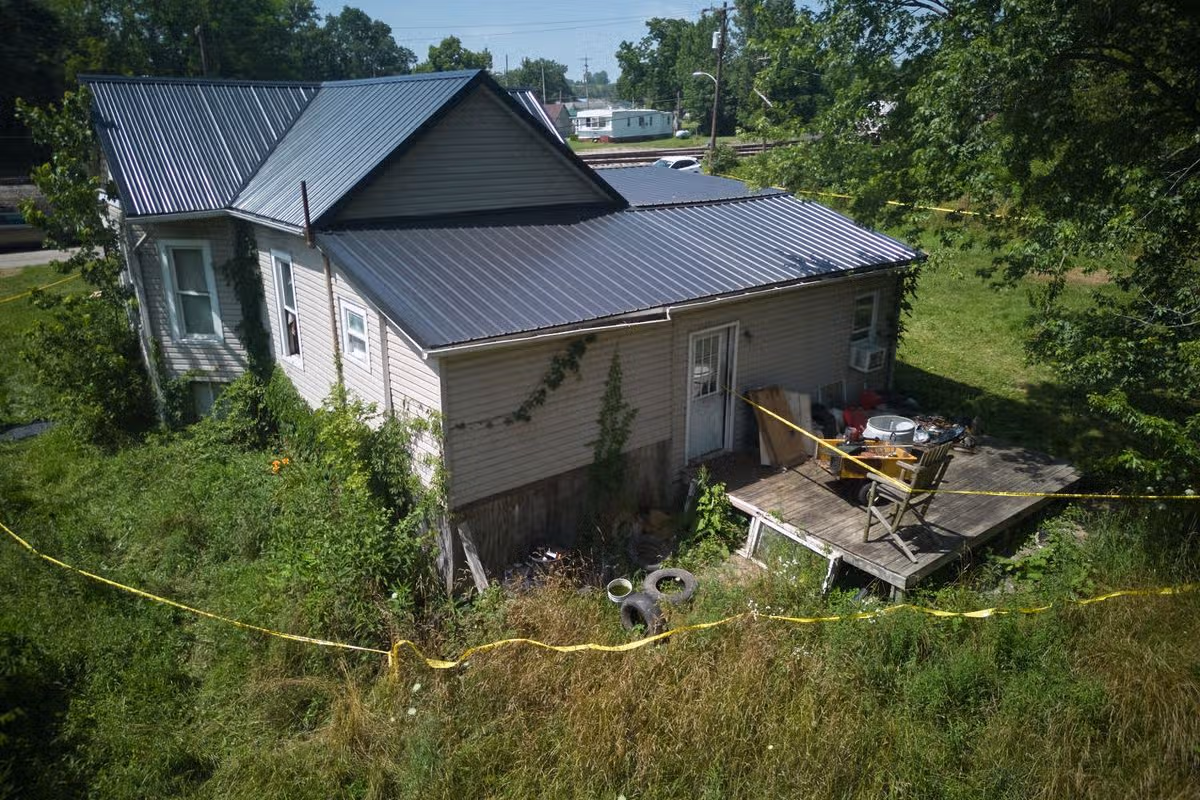 The area behind a home where authorities say they removed 16 children and arrested four adults is seen in Hamden, Ohio, Wednesday, July 1, 2026.