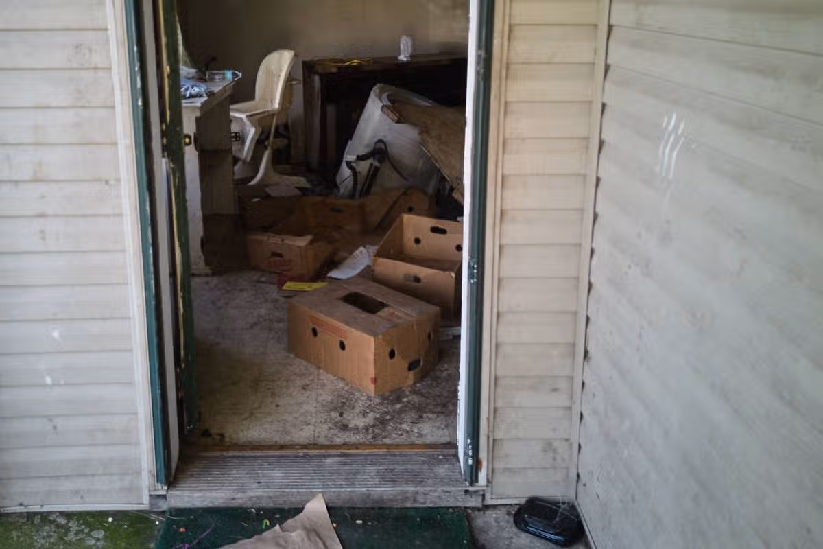 Items including a high chair are seen in a home where authorities say they removed 16 children and arrested four adults in Hamden, Ohio, Wednesday, July 1, 2026. (AP Photo/Carolyn Kaster)