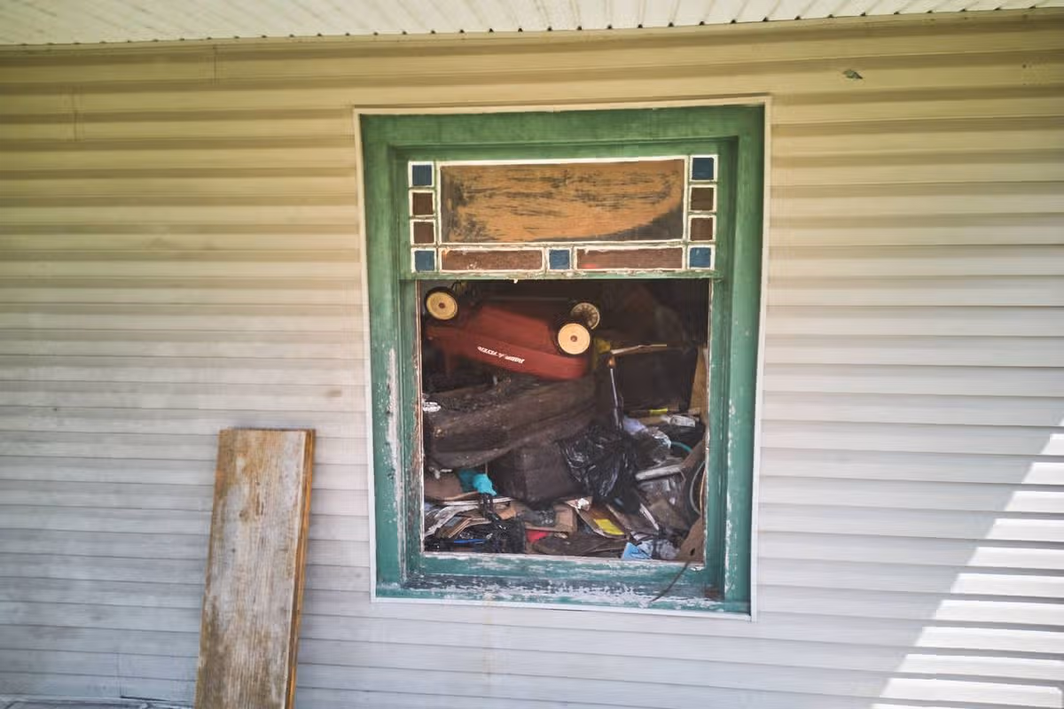 Debris is seen inside a home where authorities say they removed 16 children and arrested four adults in Hamden, Ohio, Wednesday, July 1, 2026. (AP Photo/Carolyn Kaster)