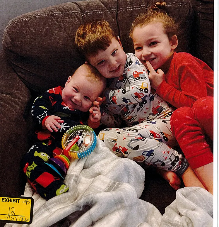 Callan, Dawson and Cora Clancy snuggle up on a couch
