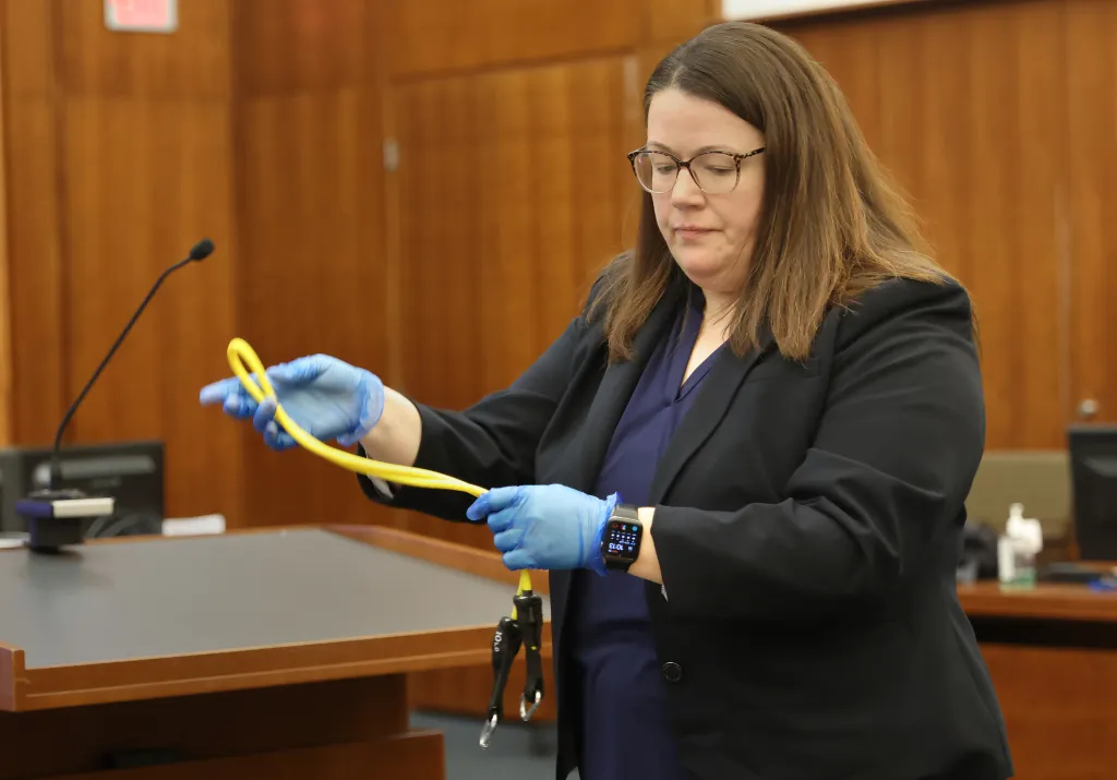 Assistant District Attorney Jennifer Sprague holds exercise band during the trial