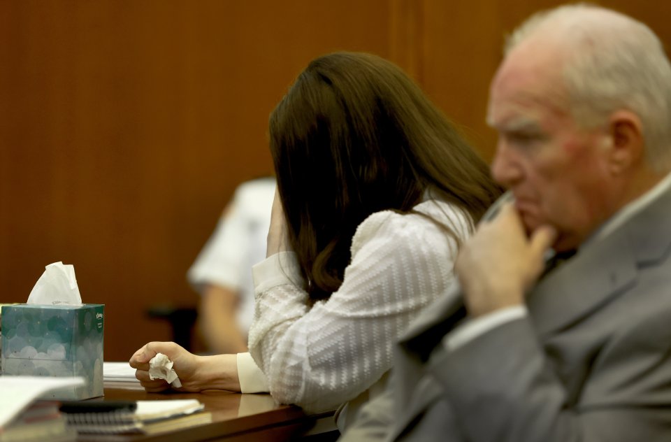 Lindsay Clancy clutches a tissue during her murder trial.