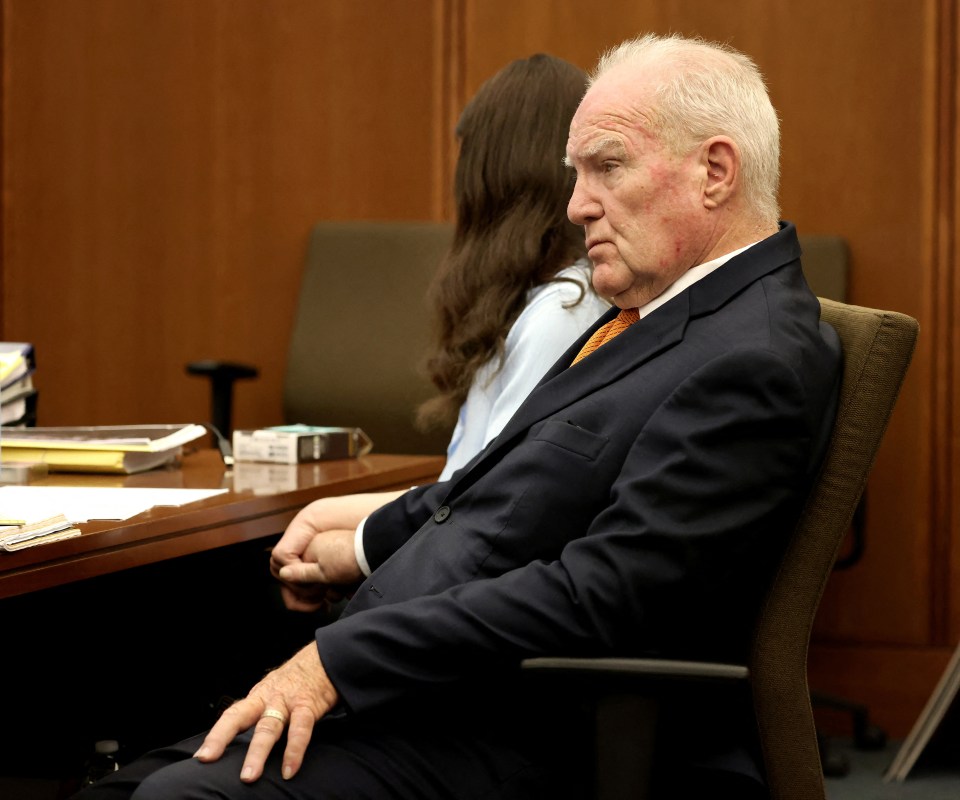Defense attorney Kevin Reddington holds the hand of Lindsay Clancy during her murder trial.