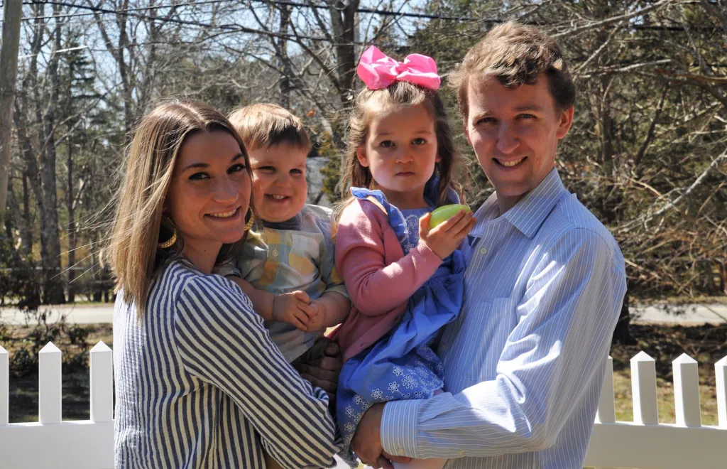 Family portrait of a man, woman, and two young children.