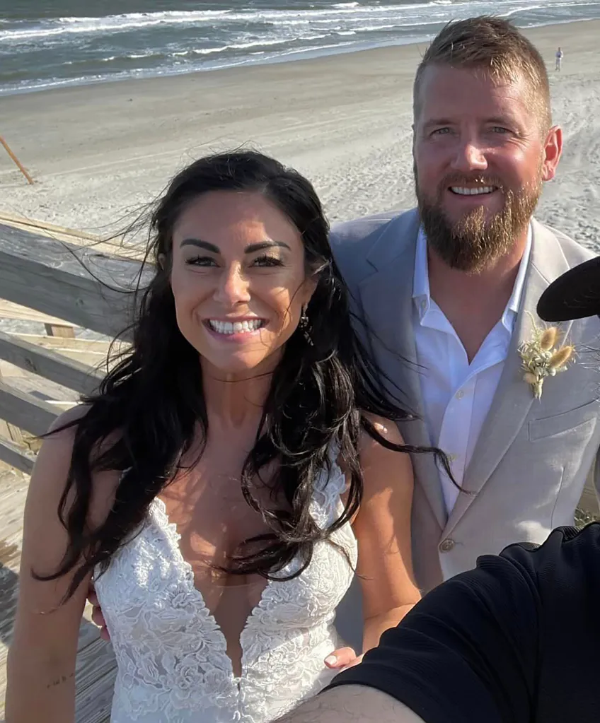 Samantha Hutchinson smiling on her wedding day with her husband Aric Hutchinson, at a beach in Folly Beach, South Carolina.