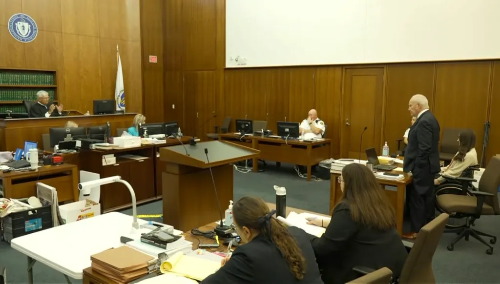 Courtroom with a judge, lawyers, and spectators.