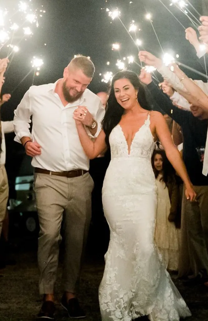 Aric and Samantha Hutchinson walking through sparklers on their wedding night.