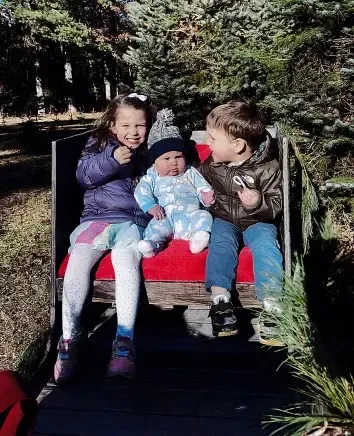 Cora, Callan, and Dawson Clancy sitting together.
