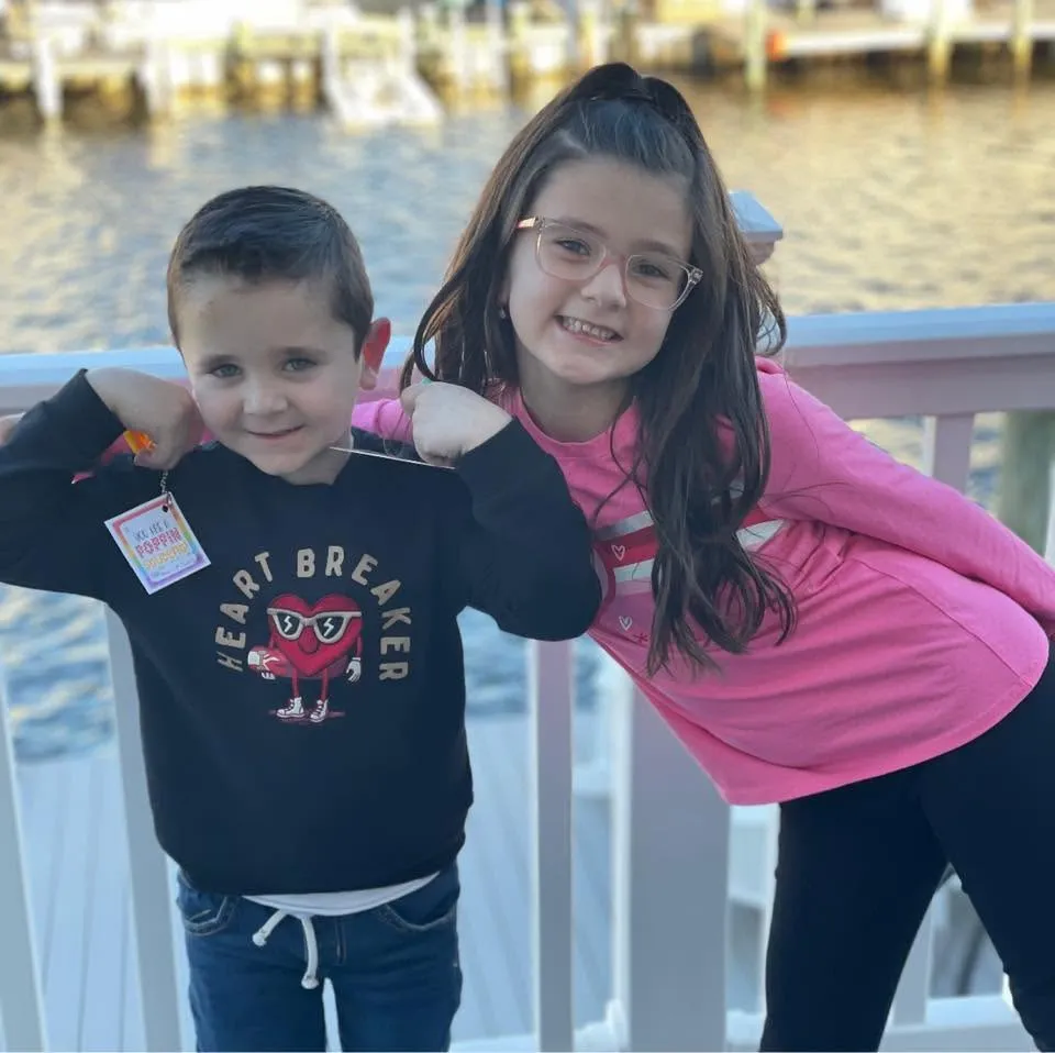 Sigmund Golabek, 7, and Mya Golabek, 9, stand smiling for a photo.