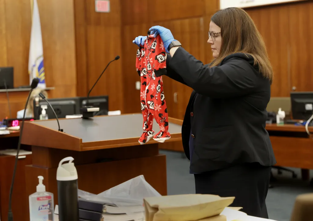 Assistant District Attorney Jennifer Sprague holding up Mickey Mouse pajamas in court.
