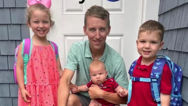 Patrick Clancy smiling with his three children, 5-year-old Cora, 3-year-old Dawson, and 8-month-old Callan.