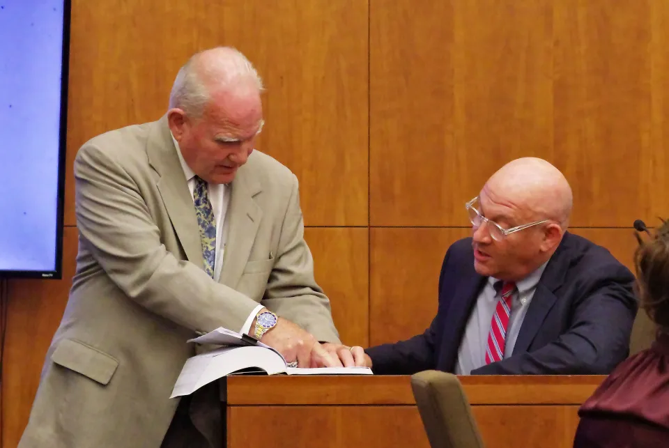 Defense Attorney Kevin Reddington shows a psychology book to Dr. Avram Mack during the Lindsay Clancy trial.