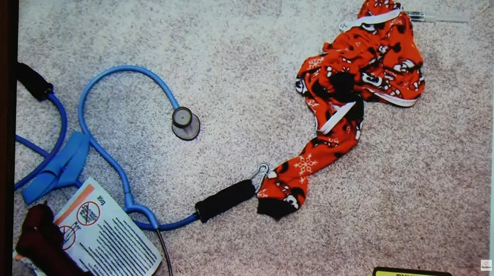Callan's red pajamas with a Mickey Mouse pattern next to a blue stethoscope and exercise bands.