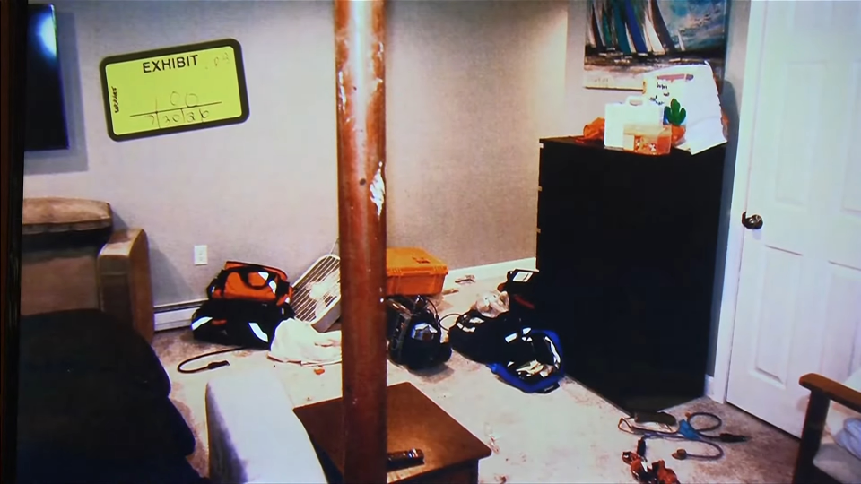Basement crime scene with forensic markers.
