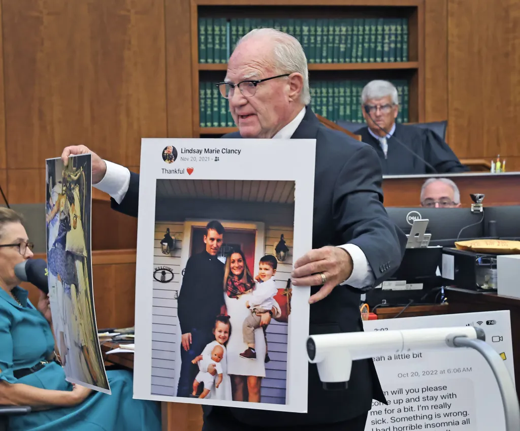 Defense attorney Kevin Reddington holds up a picture of the Clancy family before the murders during closing arguments in the Lindsay Clancy murder trial.