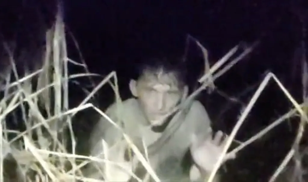 Isaac Kinsey, accused of DUI, crawling through a swamp.