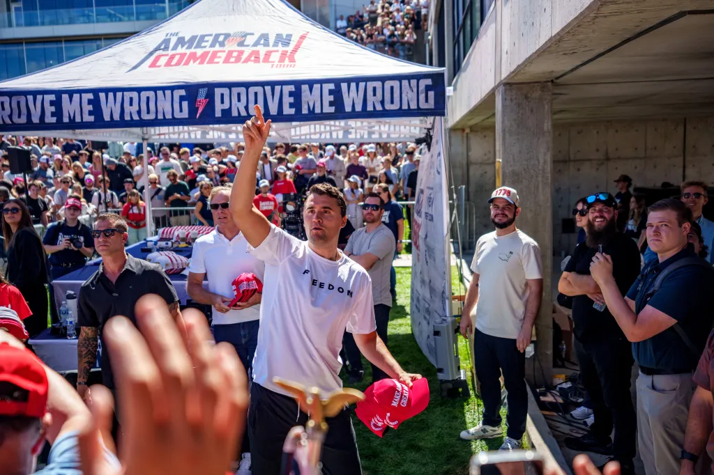 Charlie Kirk throwing hats to a crowd at Utah Valley University during his "American Comeback Tour."