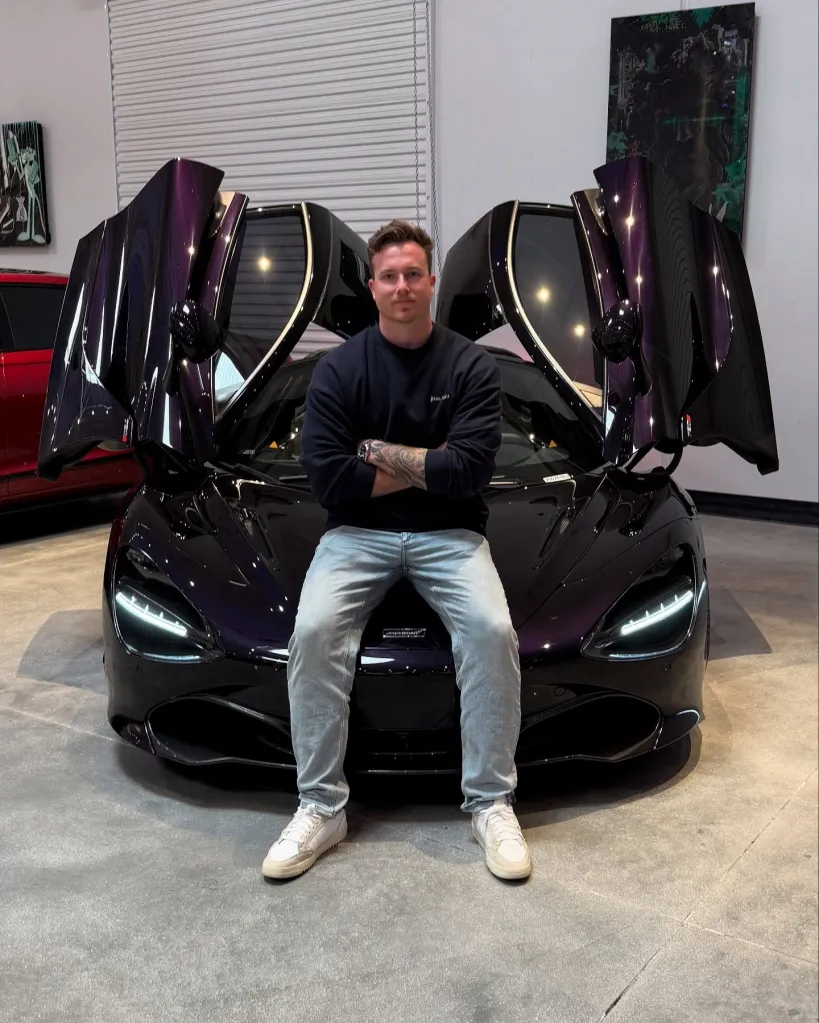 James Wehr sitting on the hood of a purple 2019 McLaren 720S with its butterfly doors open.