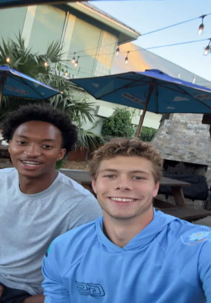 Close-up photo of Nolan Wells and Jax Pitalo smiling at the camera outdoors.