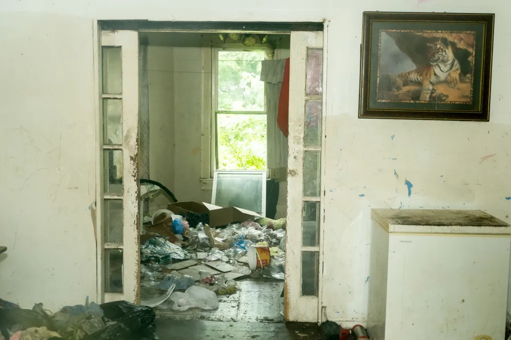 An interior view of a room in the Siders' home, filled with trash and debris.