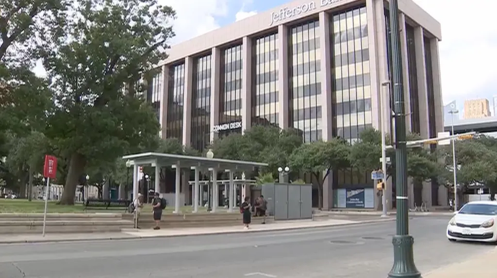 Jennifer Benavides stands at a bus stop in downtown San Antonio, Texas.