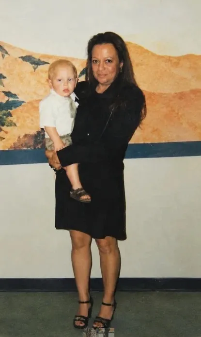 Photo of Vickie Swartout holding a young child.