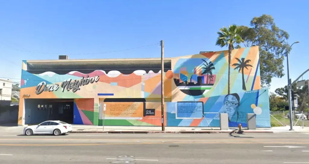 Exterior view of the 1736 Crisis Center, featuring a colorful mural on the facade, located in Los Angeles' Arlington Heights neighborhood.