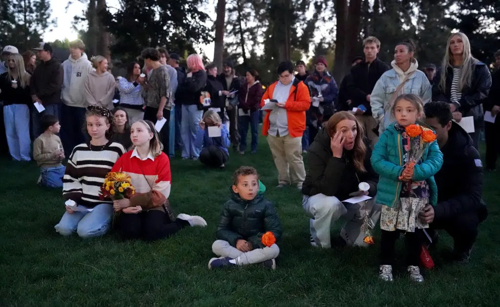 People gather for a candlelight vigil held in Drake Park in Bend, Ore., on Oct. 15, 2026, following a shooting at Silver Rail Elementary School.