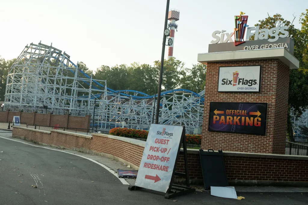 Six Flags Over Georgia entrance with a roller coaster in the background.