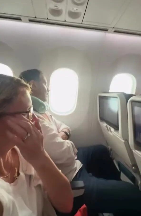 Tomiko and a woman crying on a flight after Tomiko refused to switch seats.