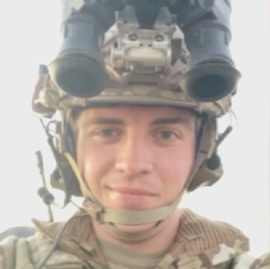Air Force Sergeant Ian Patterson wearing a military helmet with night vision goggles.