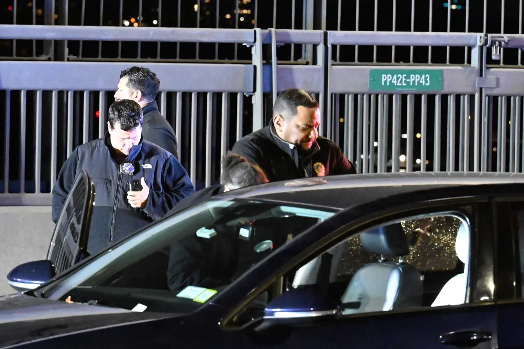 Law enforcement officers investigate the scene of a fatal shooting on the George Washington Bridge.