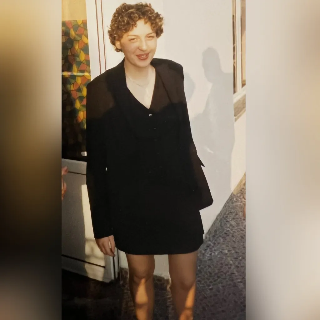 Taylor Winters posing in a dress before transitioning.