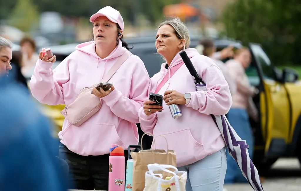 Supporters of Lindsay Clancy wearing pink hoodies stand outside Plymouth Superior Court.