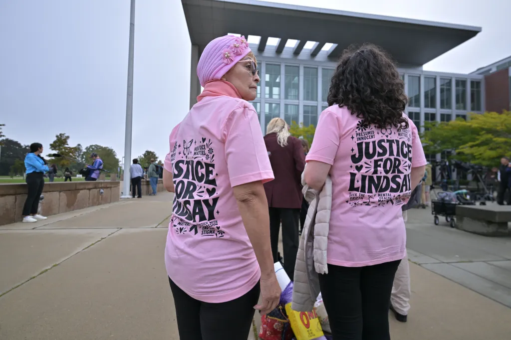 Supporters of Lindsay Clancy wearing matching pink shirts outside Plymouth Superior Court.