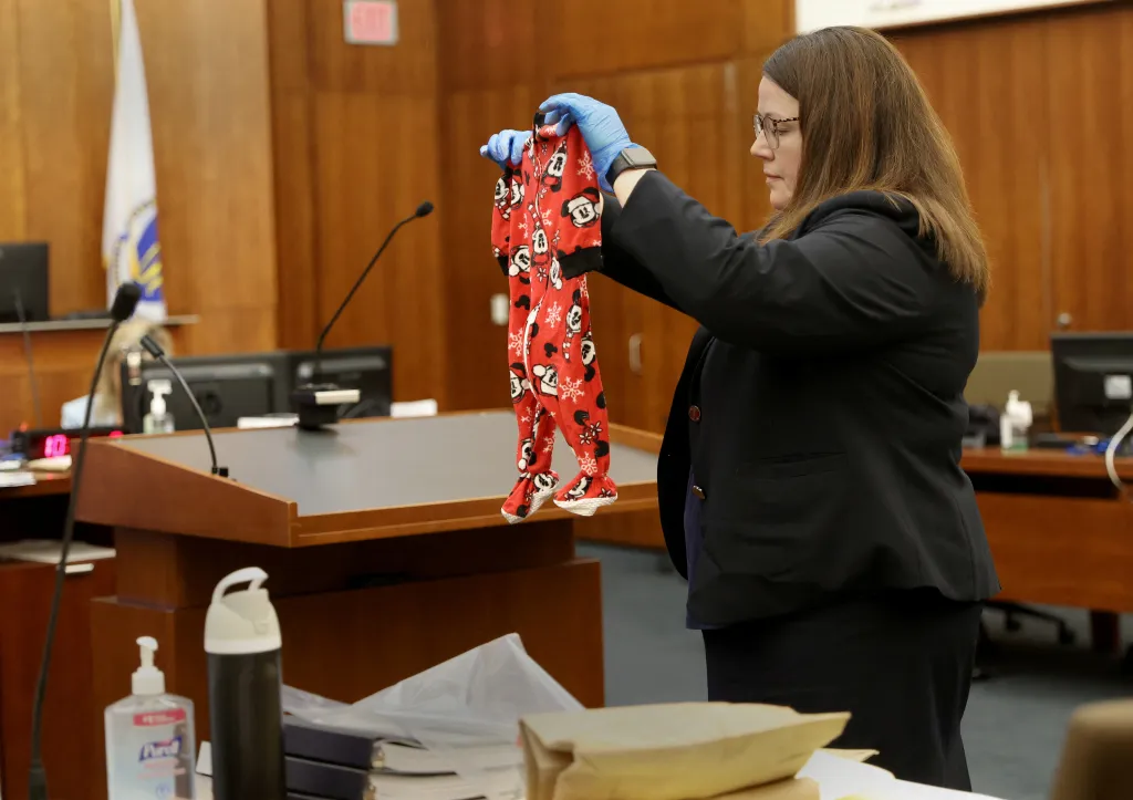 Assistant DA Jennifer Sprague holds up as evidence the pajamas of Callan Clancy during a trial in Plymouth Superior Court.