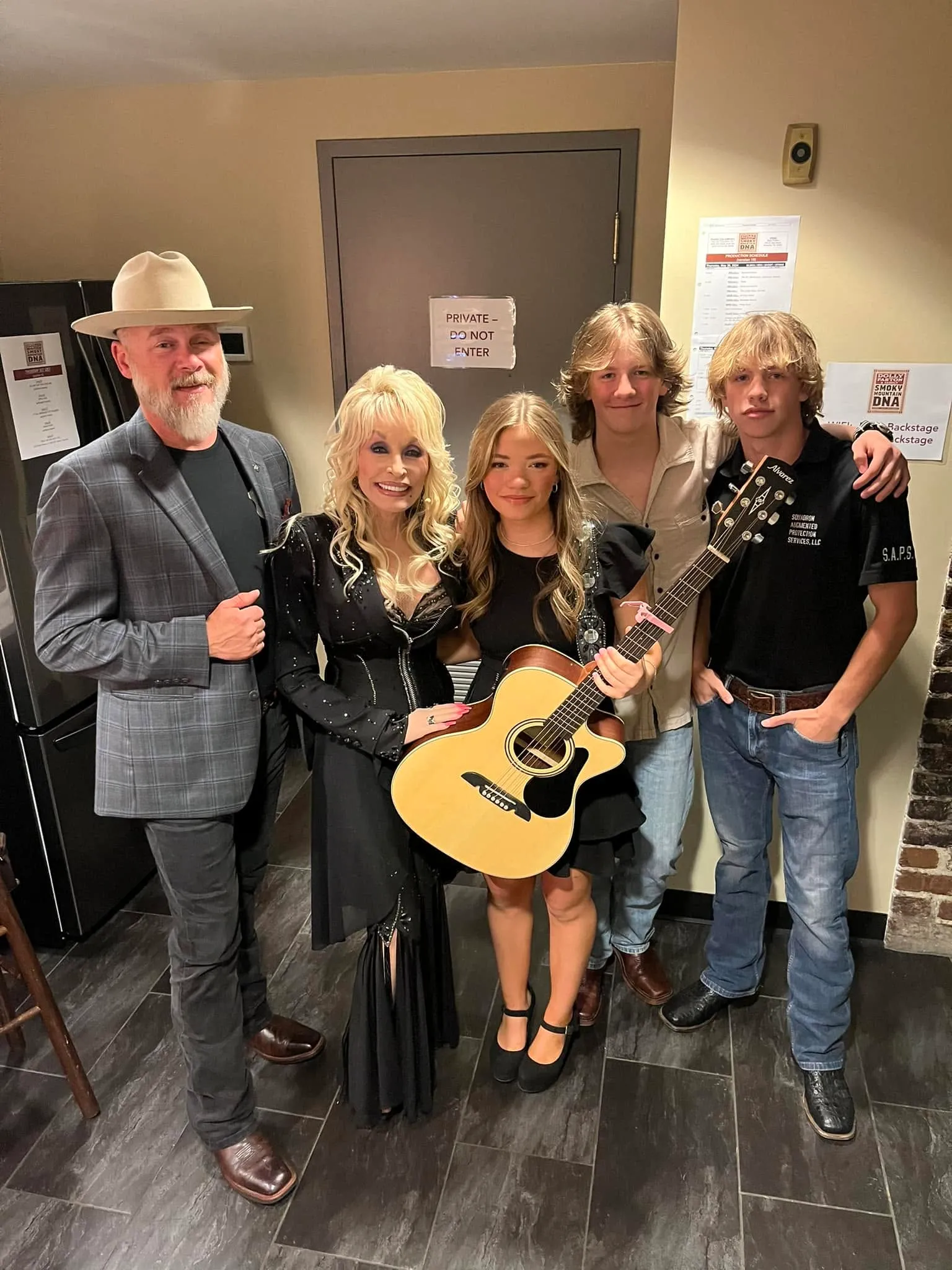 Dolly Parton poses indoors with Bryan Seaver and his family.