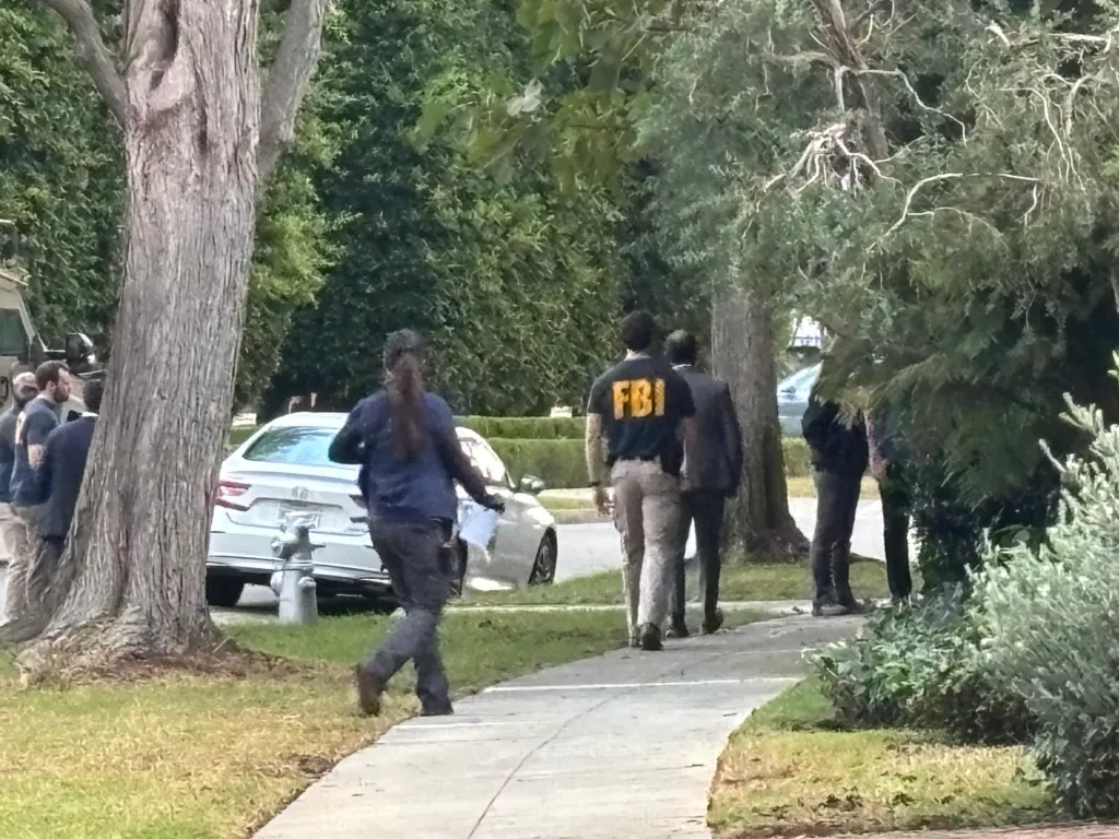 FBI agents outside Stephen Cloobeck's Beverly Hills home.