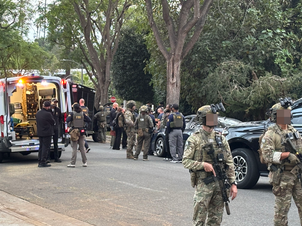 FBI agents outside Stephen Cloobeck's house in Beverly Hills.