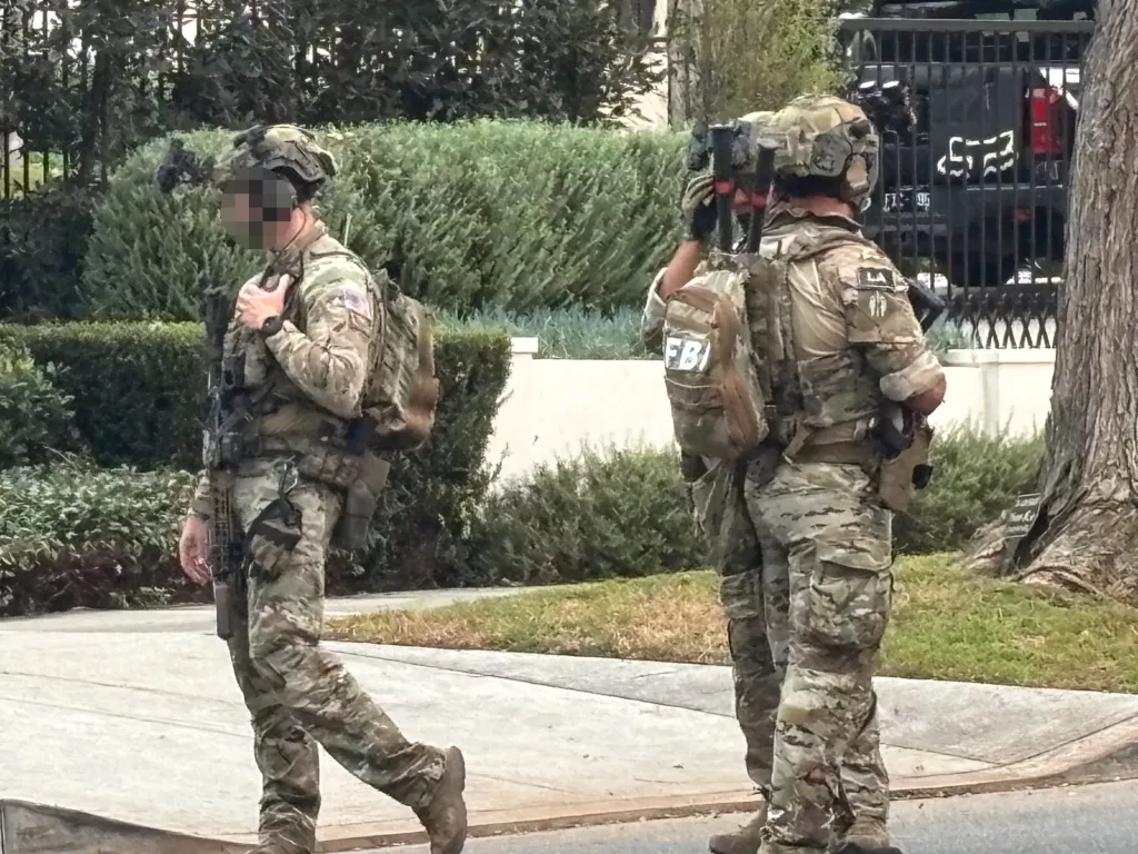 FBI agents in tactical gear outside Stephen Cloobeck's Beverly Hills house.
