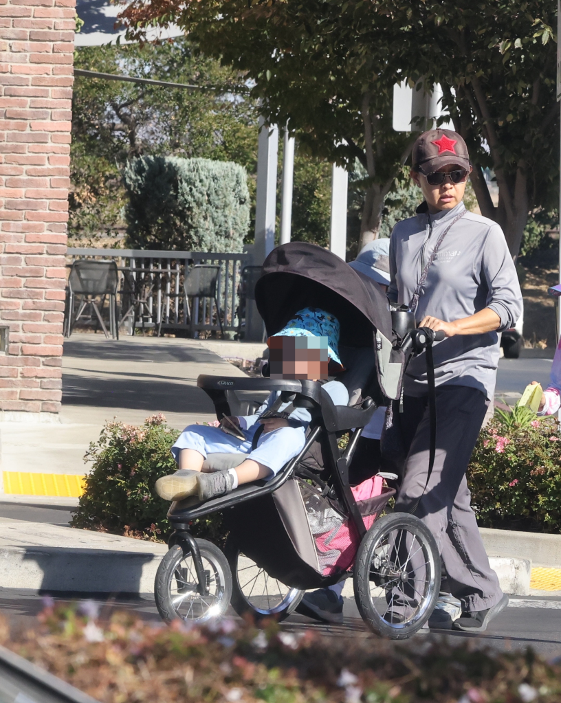 Candice Jang walks with her child in Oakland, Calif.