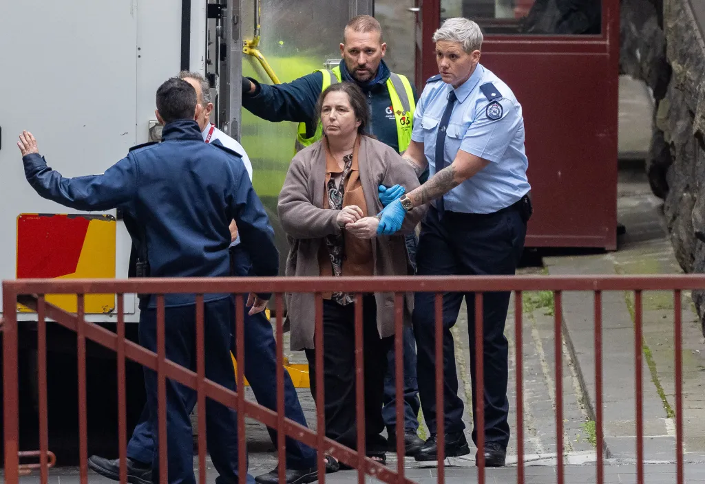 Convicted triple-murderer Erin Patterson escorted by officers to the Supreme Court of Victoria.