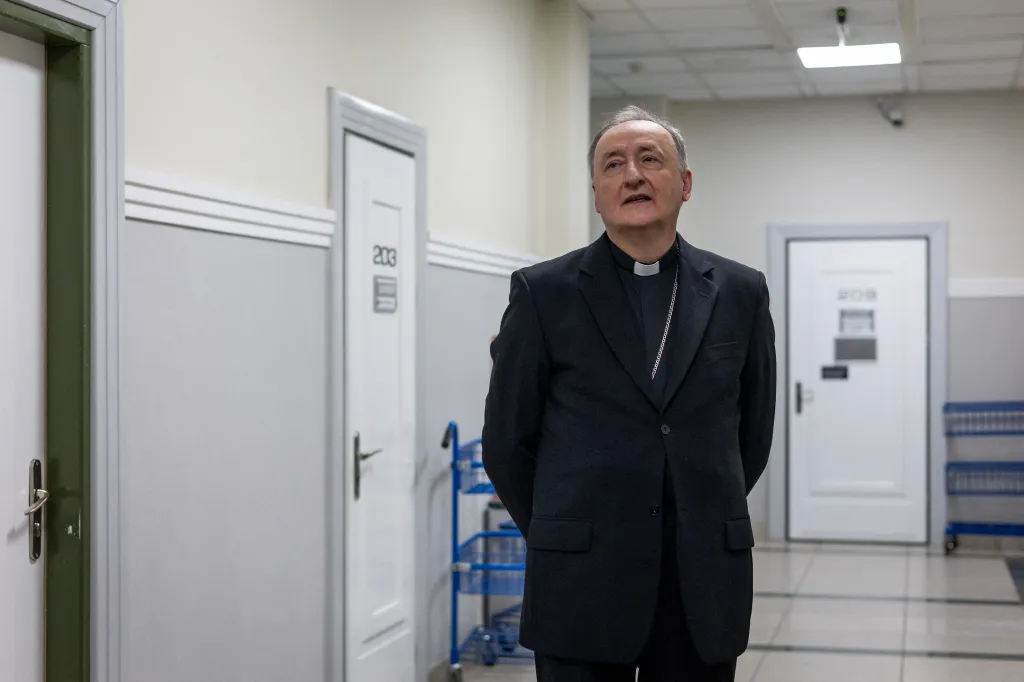 Bishop Andrzej Jez waits in a court corridor in Tarnow, Poland.