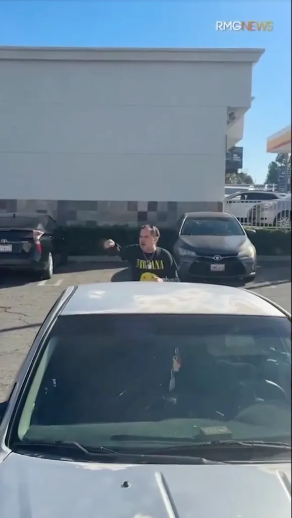 A knife-wielding suspect stands outside of a restaurant following an altercation in Los Angeles.
