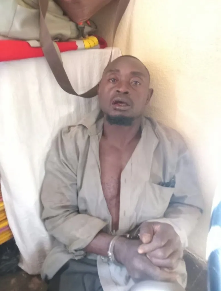 Moses Mujurizi is pictured in handcuffs.